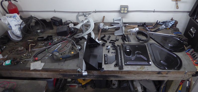 Image of painted parts in black and silver on workbench