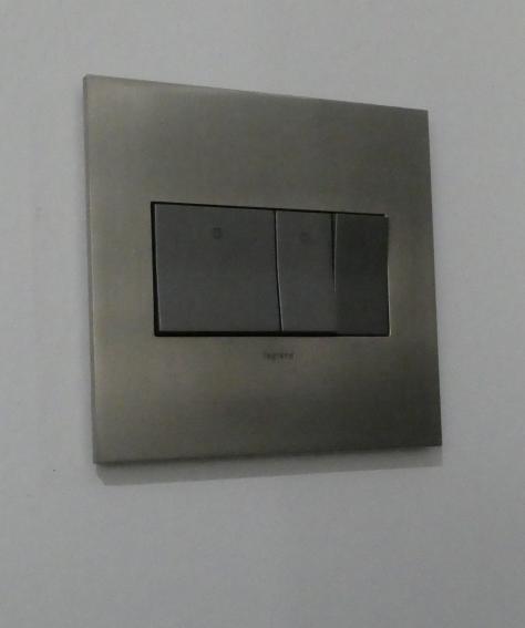 Image of Legrand Adorn bathroom switches with stainless plate, 3 gang