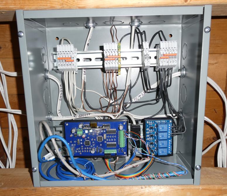 Image of bedroom control box open showing DIN terminal strips at top connecting to lights and outlets, 1284 board board at bottom with relay module controlling lights. Switches connected to board inputs.