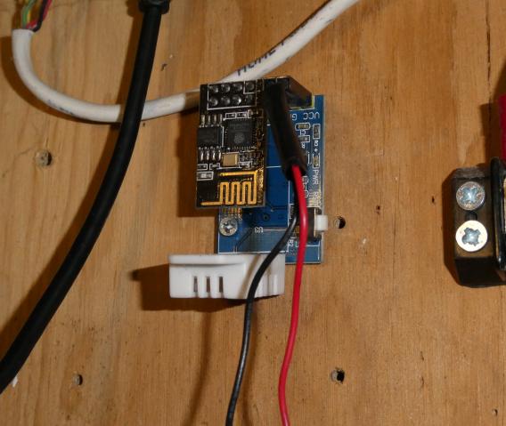 DHT22 ESP8266 ESP-01 module mounted to wood board in basement near electrical panel