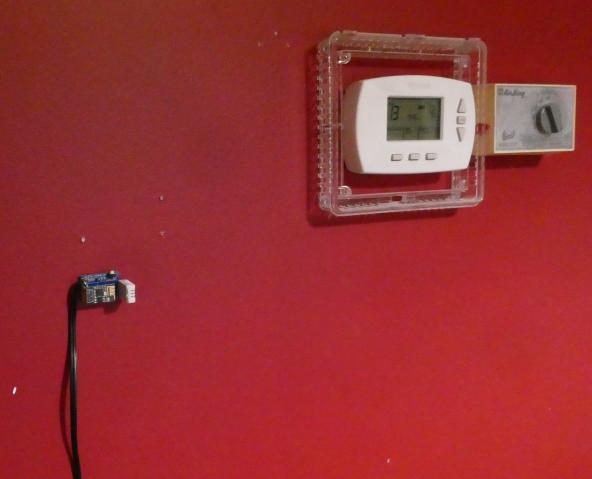 DHT22 ESP8266 ESP-01 module mounted to wall in living room near thermostat