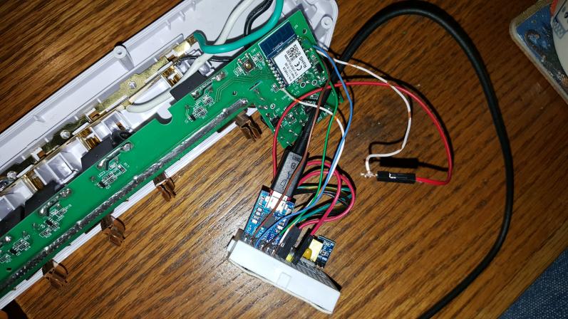 Image of GNC-SW003 WiFi power bar opened with wires connected to TYWE3S module to flash firmware via USB to serial