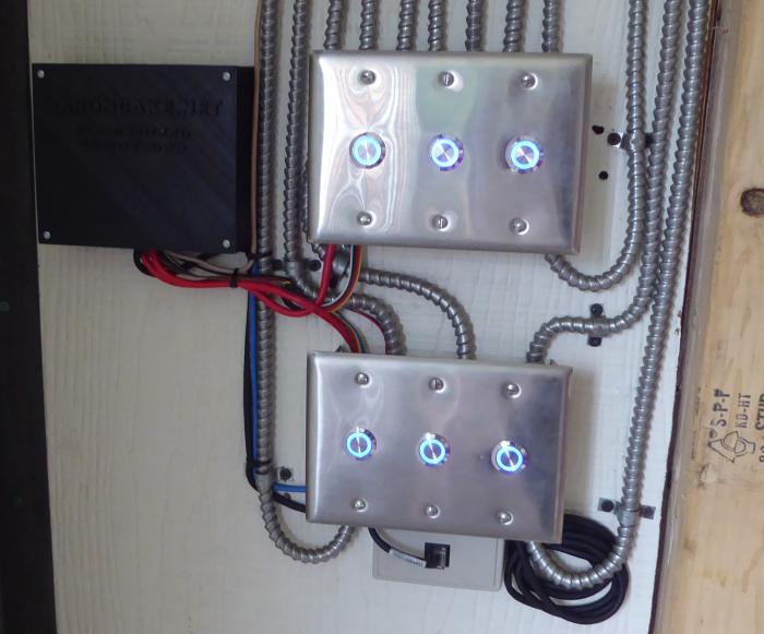 Image of Nano board, switchboxes beside with stainless steel plates having installed buttons