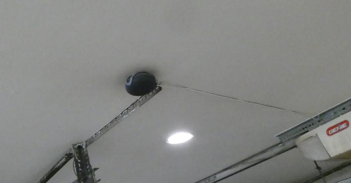 Image of Google Home Mini mounted to shop ceiling in 3D printed bracket