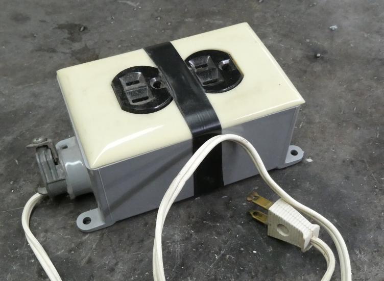 Image of ESP8266 relay controlled WiFi outlet exterior with grey PCV box and cord