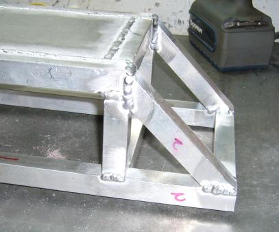 Angled supports welded to front frame